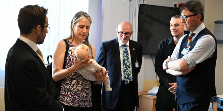 Chancellor Dr Fiona Hill holding a simulation baby patient