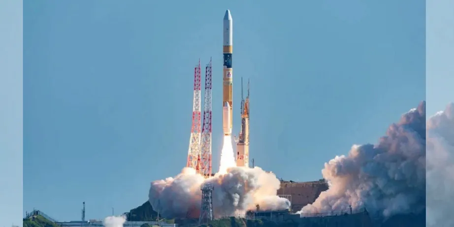 A rocket launching into a blue sky with billows of smoke beneath it
