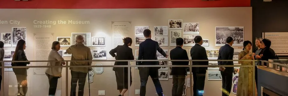 People viewing display boards in a museum.