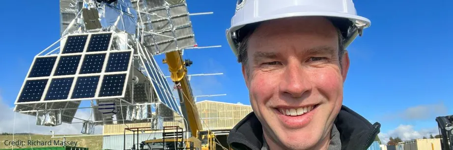 Professor Richard Massey stands in front of the crane carrying SuperBIT