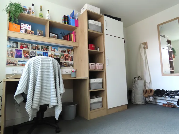 A view of a student desk space and wardrobe.