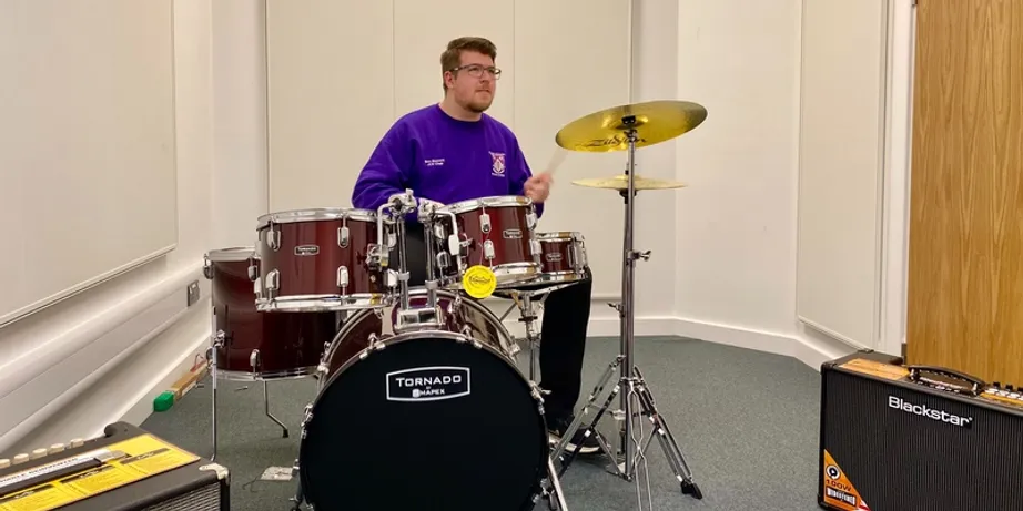 A student playing the drums