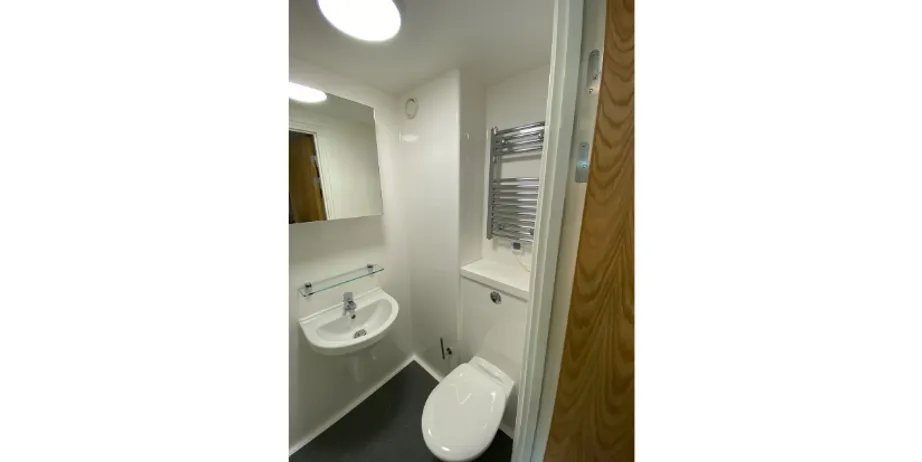 A picture of a toilet, sink, and mirror