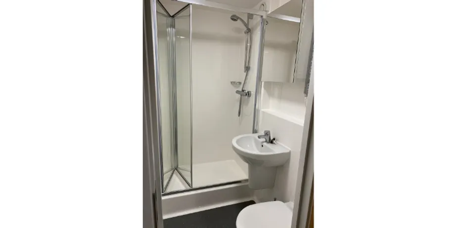 A picture of a bathroom with a sink, toilet and shower