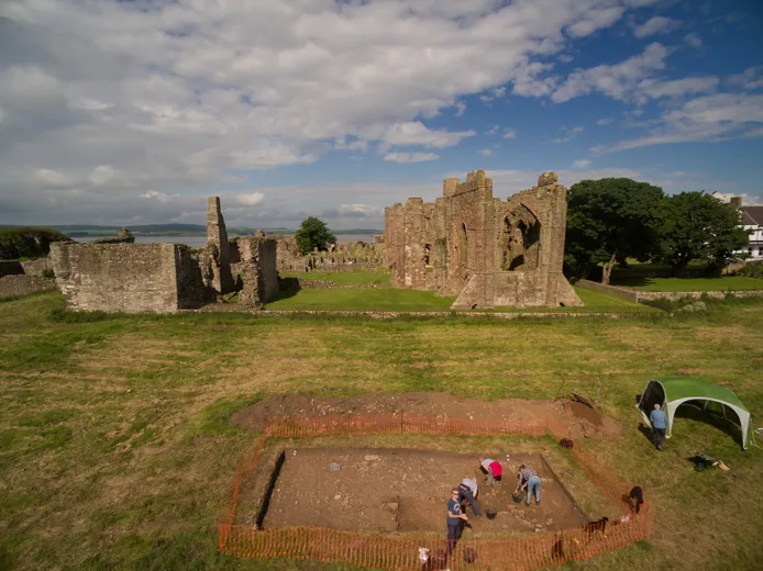 Students undertaking fieldwork in front of Lindisfarne Castle