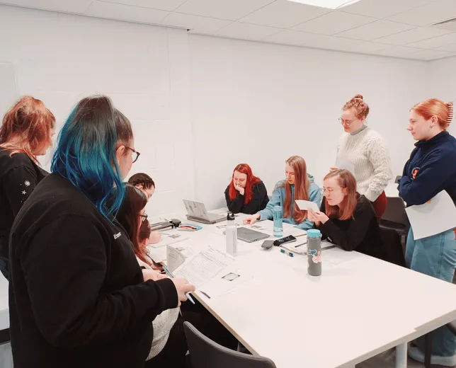Forensic Arch and Anth Students examining interpol forms