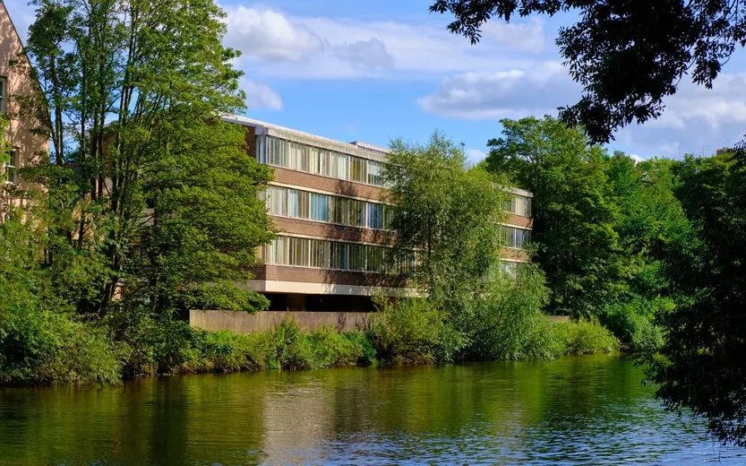 View of the Elvet Riverside building with river and trees