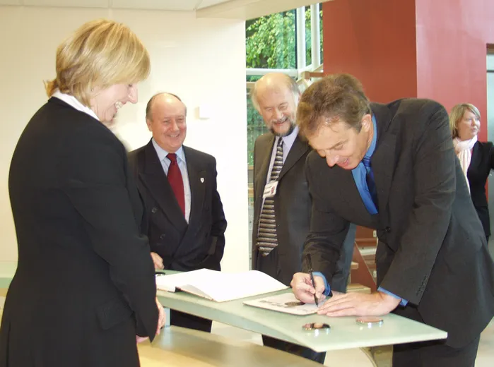 Tony Blair signs the register in the lobby of the Ogden East building