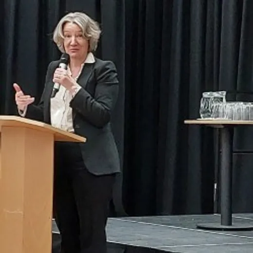 Lady talking in black suit