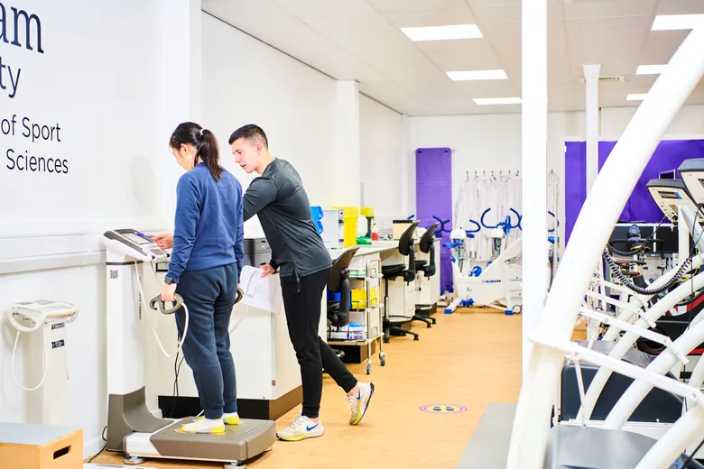 Two students participating in sport science laboratory class.