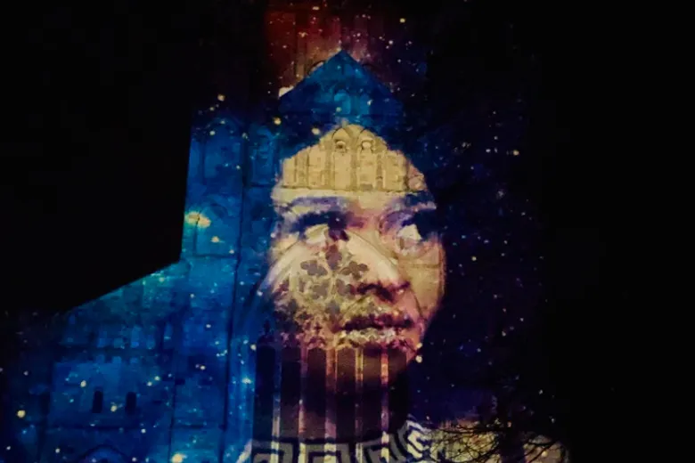 Durham Cathedral illuminated with a womans face