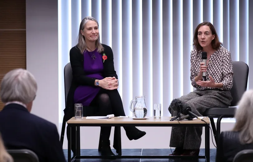Two woman in front of an audience