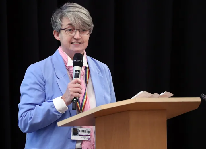 Woman speaking in front of people