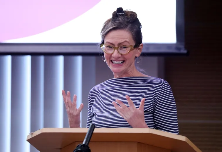 A professor speaking in front of an audience