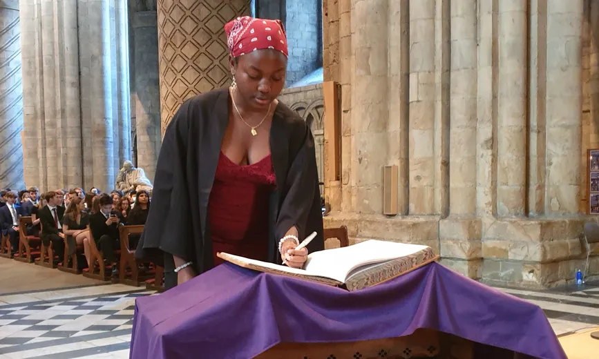 A College representative signing the Matriculation book on behalf of all the students