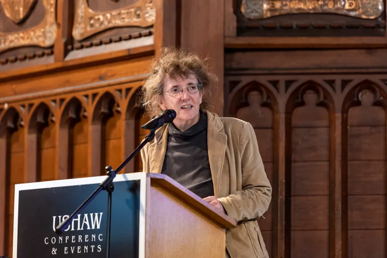 Lady speaking at a lecturn