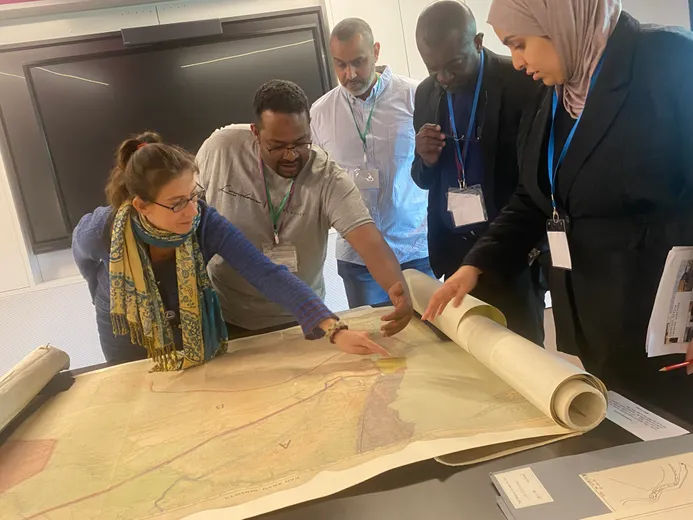 Participants at workshop looking at map