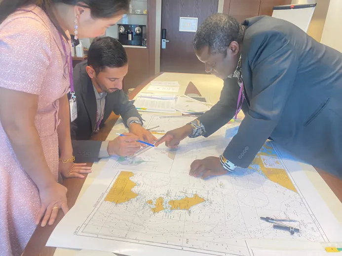 Negotiating Maritime Boundaries Participants looking at a map