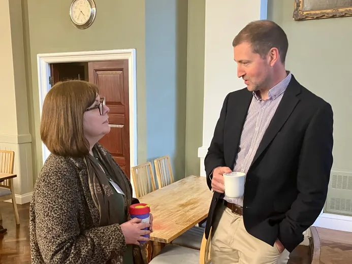Two people in deep conversation in a conference hall