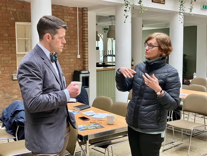 Two people in deep conversation in a conference hall