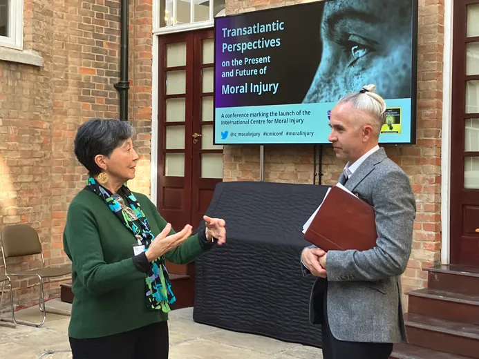 Two people in deep conversation in a conference hall