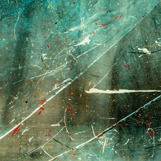 Water and paint droplets on a cracked glass pane