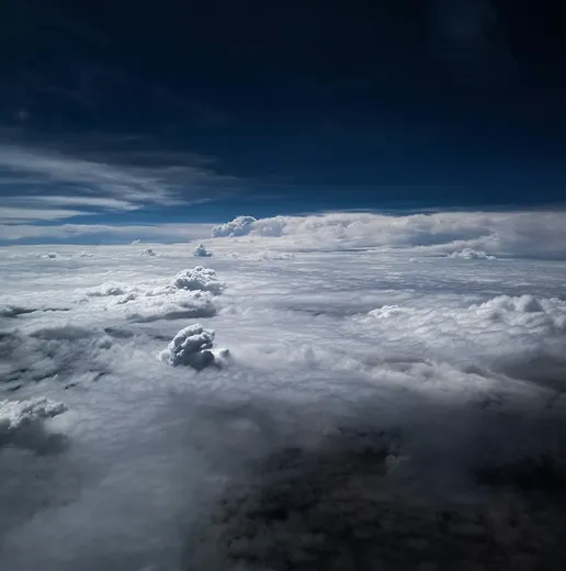 Clouds viewed from above against a dark sky
