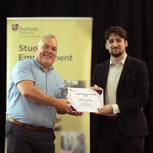 Oliver accepting his award certificate