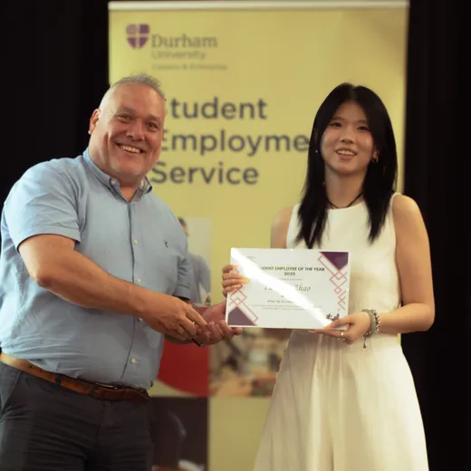 Yuetong accepting her award certificate