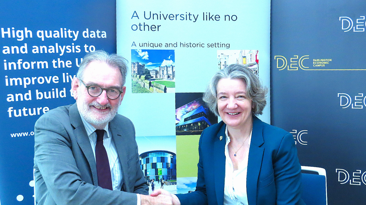 Ian Diamond and Karen O'Brien shaking hands at an MOU signing