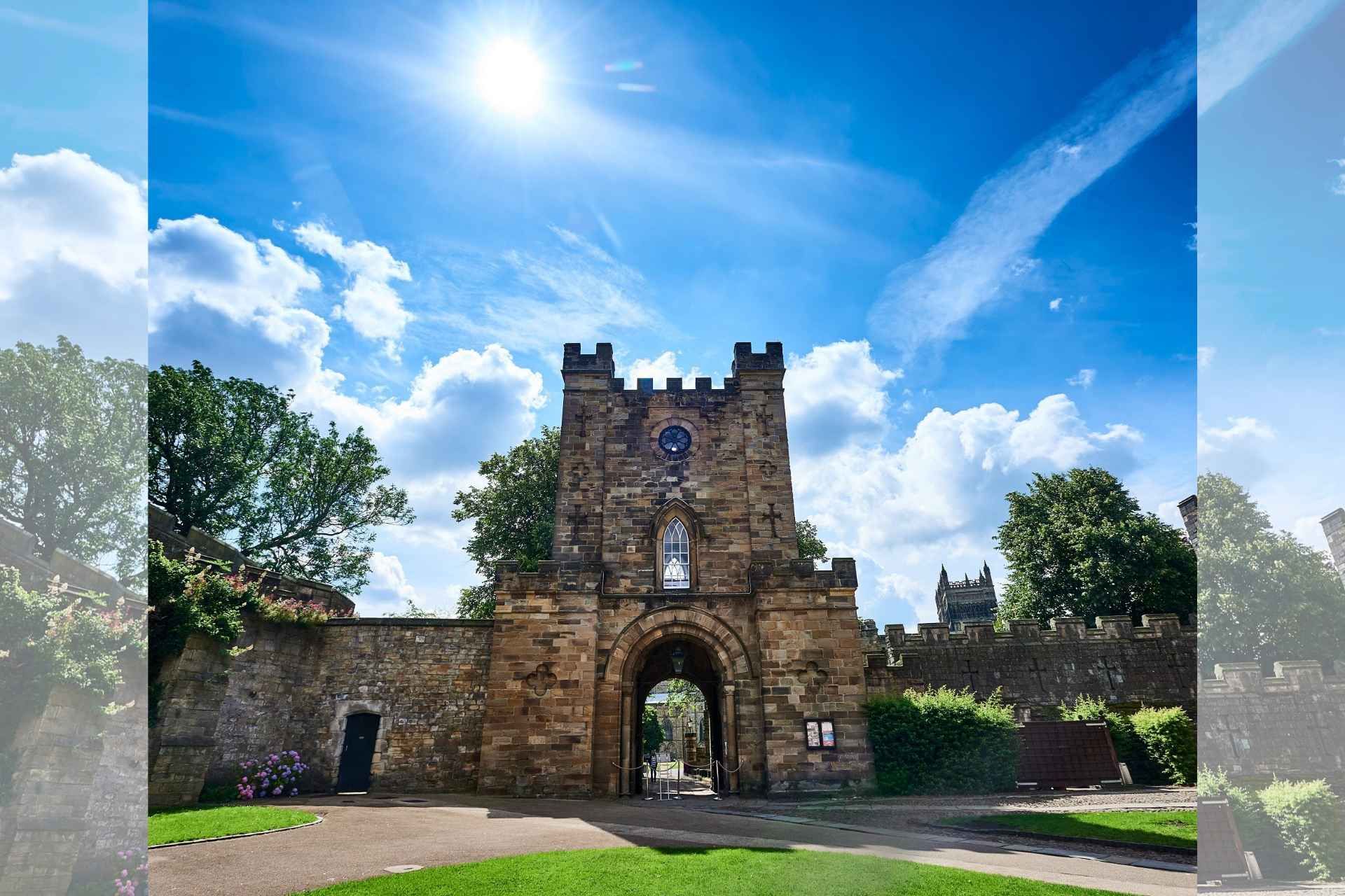 A coloured photograph of the Gatehouse from the Courtyard. The Gatehouse is at the centre of the picture, in the background are trees and Durham Cathedral.