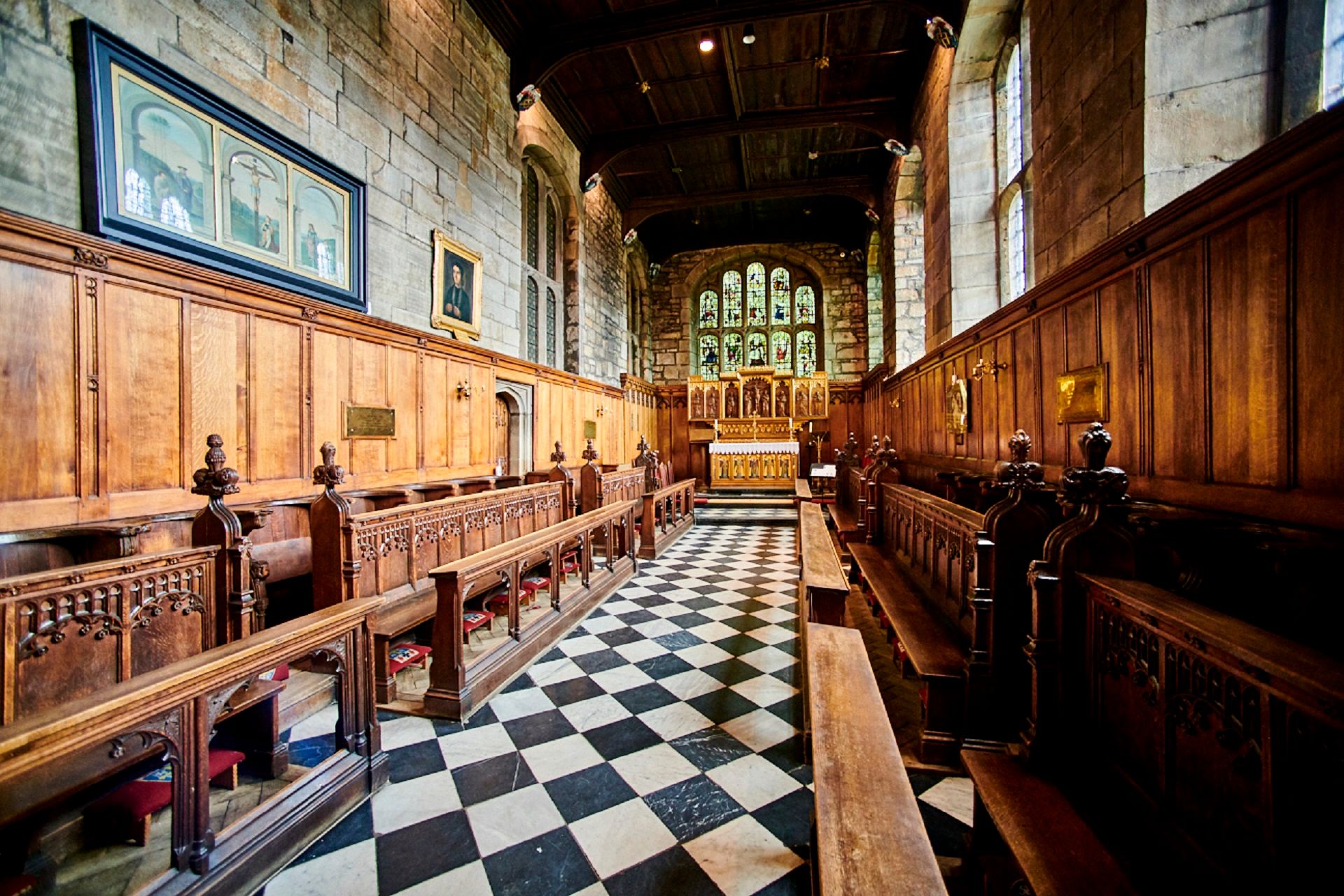 The Tunstall Chapel in Durham Castle. Looking east towards the stained-glass windows and altar.