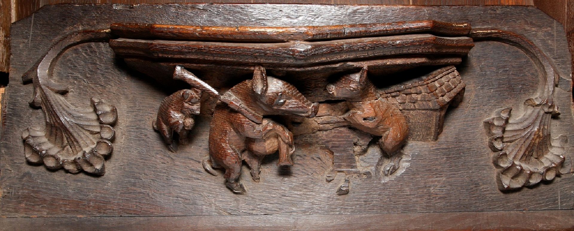 Misericord or mercy seat from the Tunstall Chapel featuring a pig playing the Northumbrian pipes.