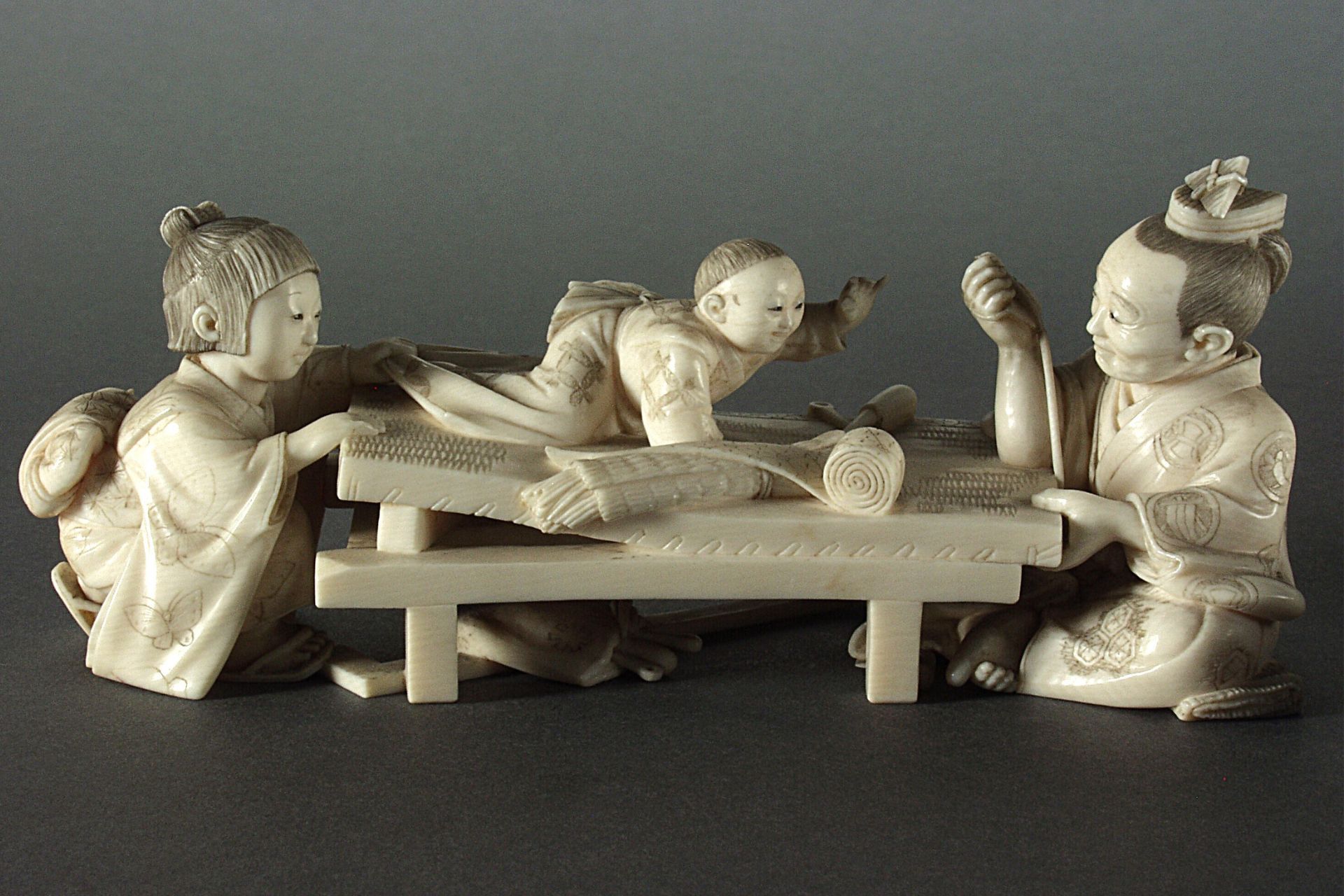 Ivory carving of a weaver and his family, dated to around 1913