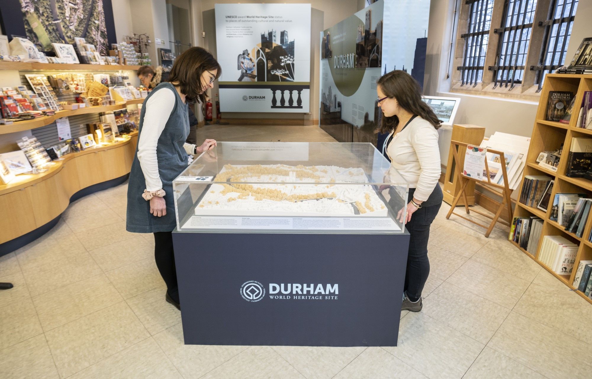 Two people looking at a model of the peninsula, showing the location of the World Heritage Visitor Centre