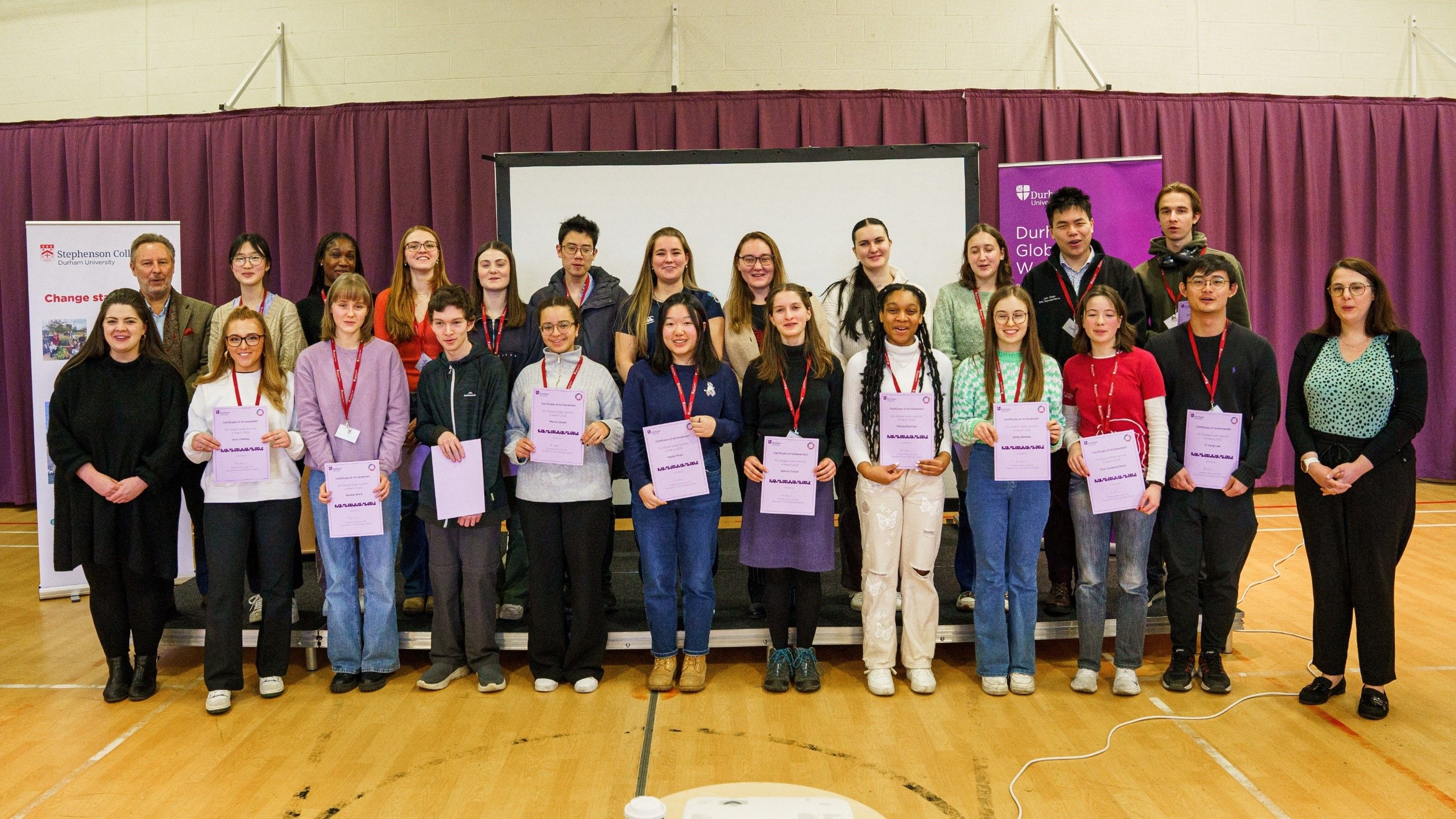 Students hold their certificates of achievement after completing the Global Goals Summit