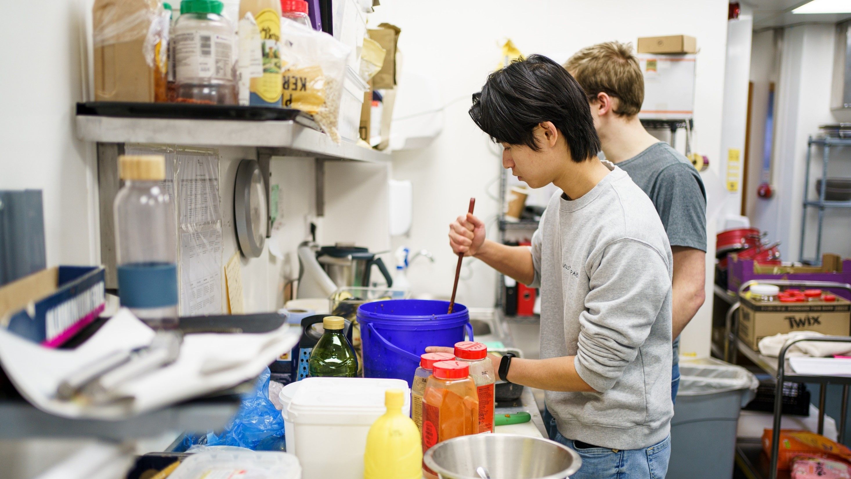 Two students preparing food in preparation for the Palatine kitchen takeover