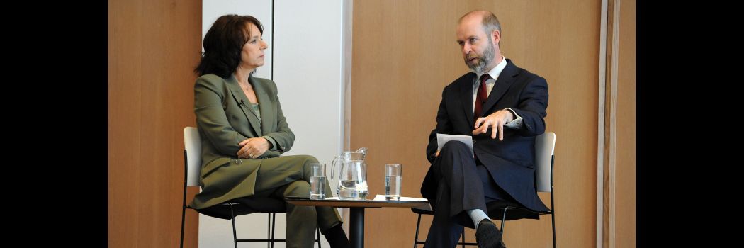 Man and woman sitting at table, man talking