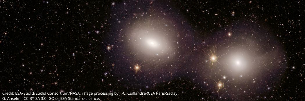 Two bright white galaxies against a starry space backdrop