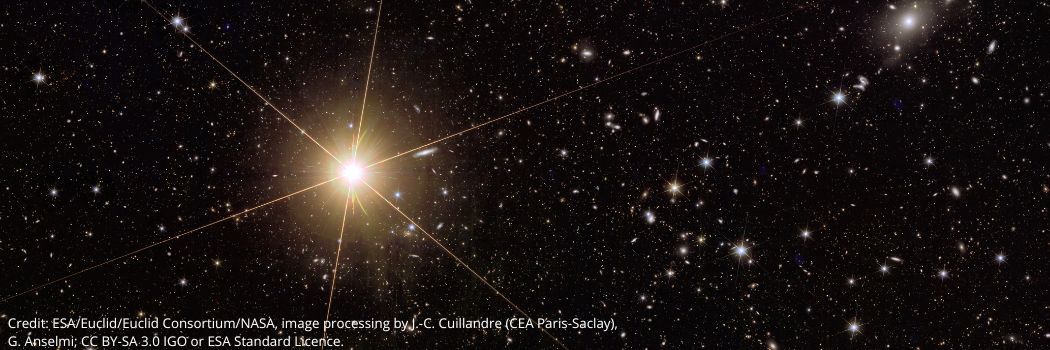 A bright star against a space black space backdrop showing stars and galaxies