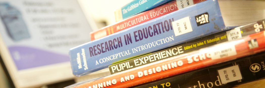 A stack of books photographed showing the spines of the books