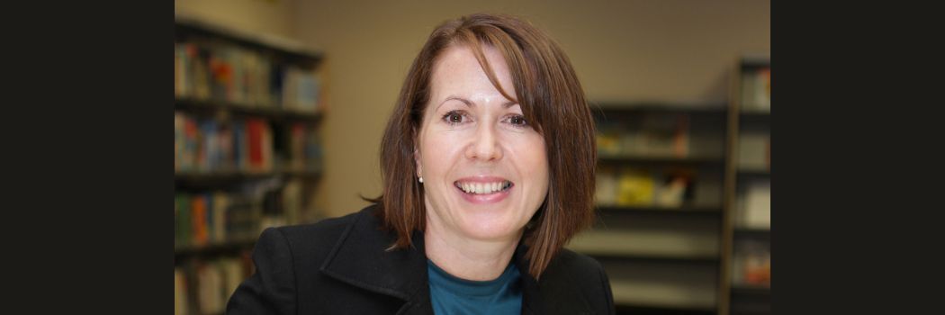 A portrait of Suzanne Duncan looking at the camera and smiling.