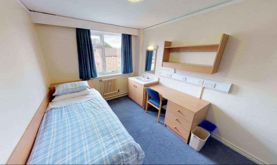 Student bedroom with a single bed and desk