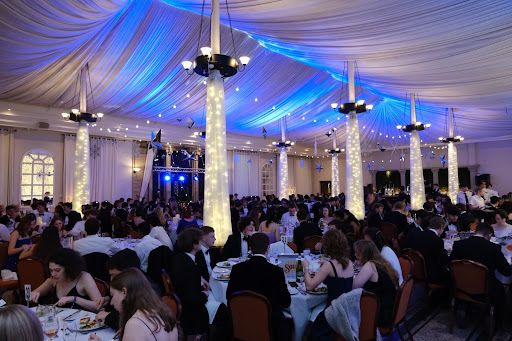 A wide shot of students eating dinner at the Grey College Phoenix Ball formal.