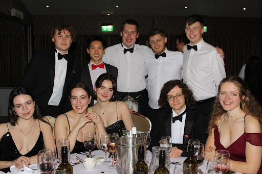 A group of students posing in black-tie attire at the Grey College Middle Common Room formal.