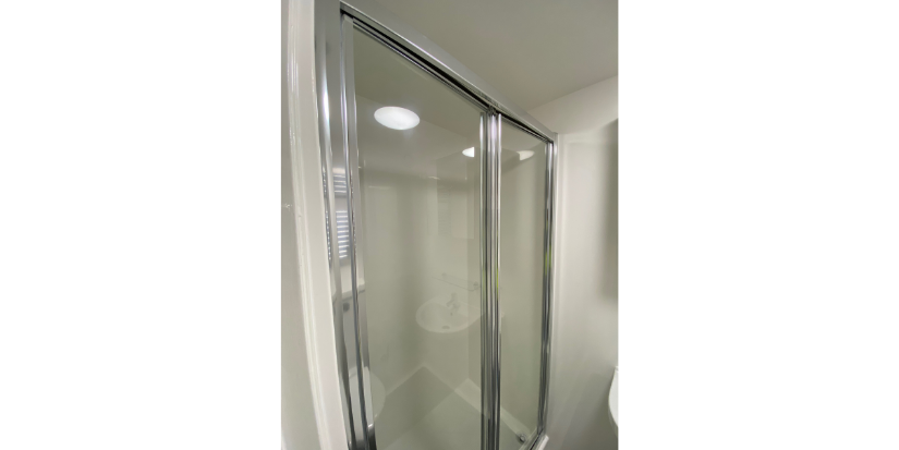 A picture of a shower door in one of our en-suite blocks