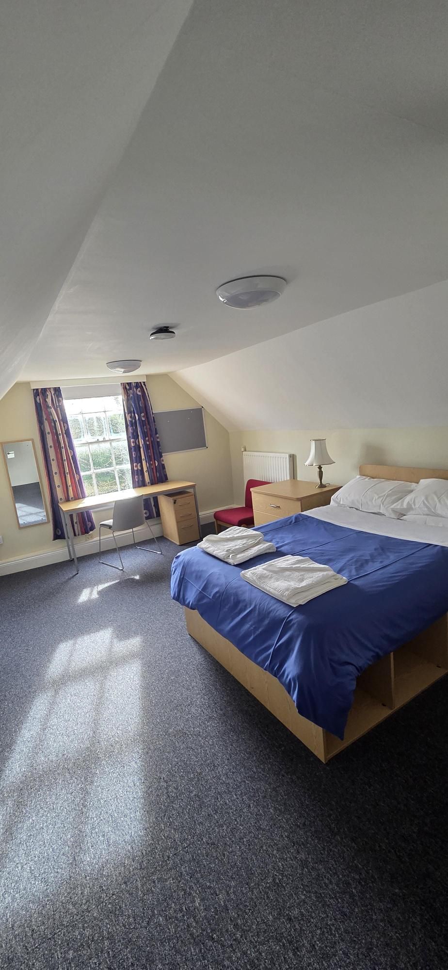 A made double bed and window
