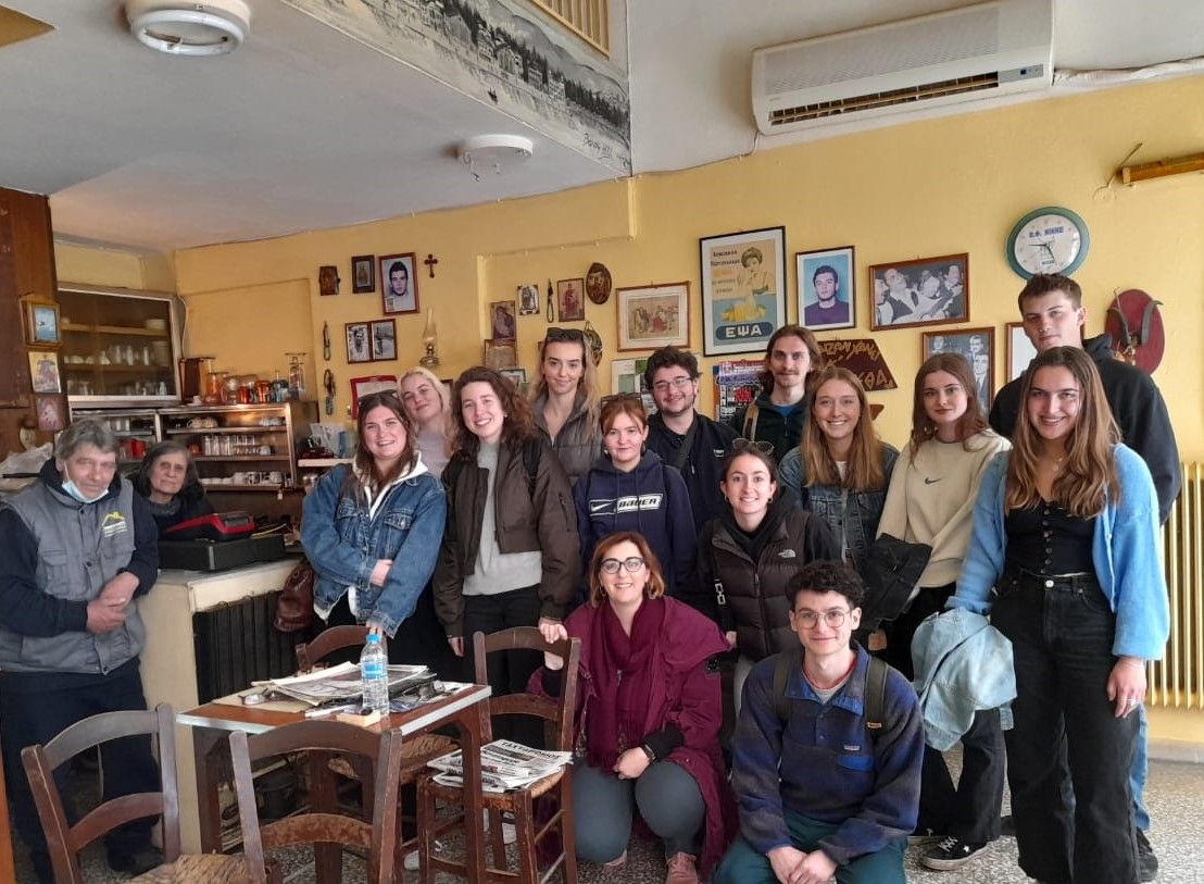 Group of people looking at camera in a greek cafe