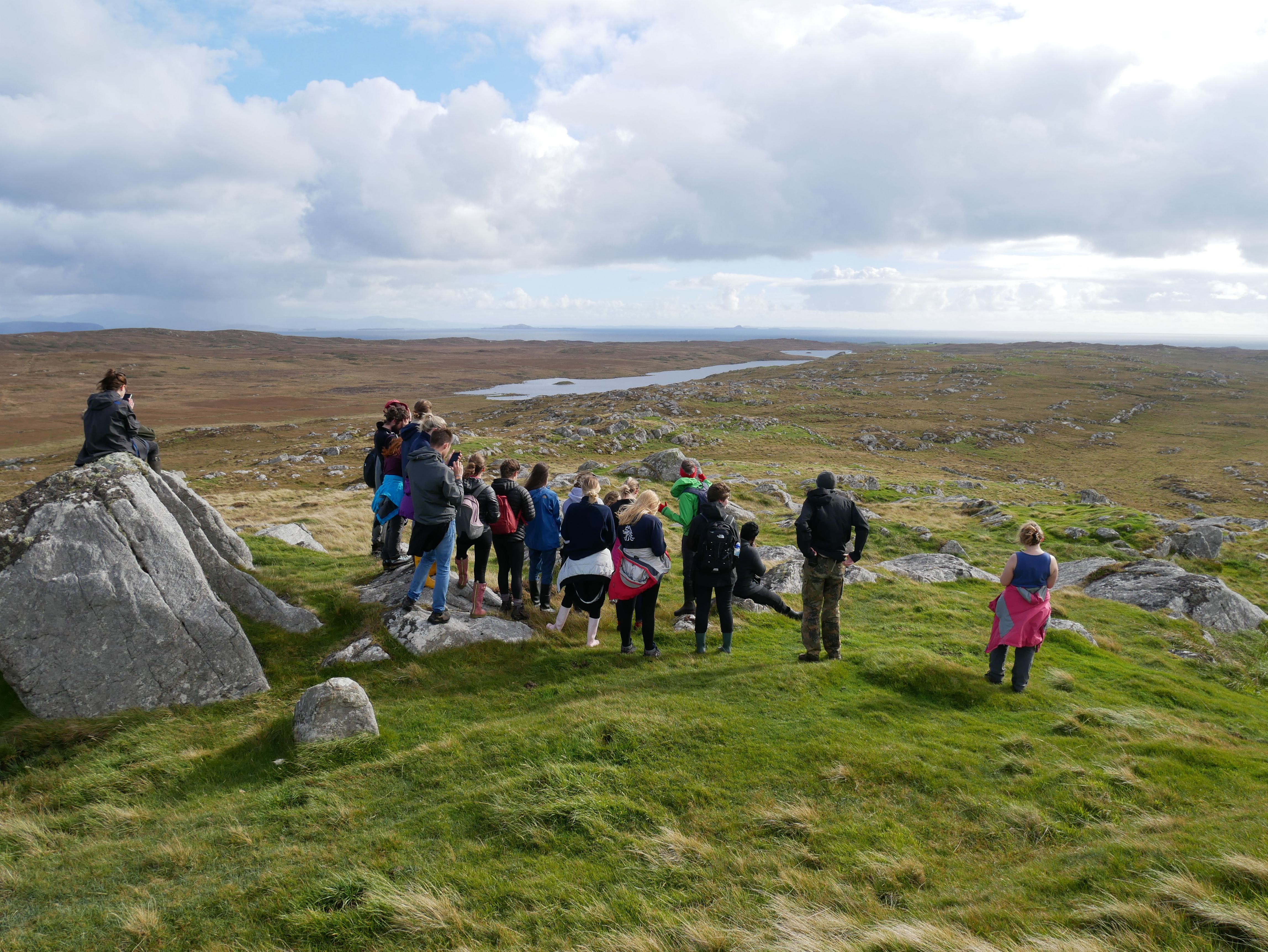 Students taking photos of expansive rugged and rocky terrain