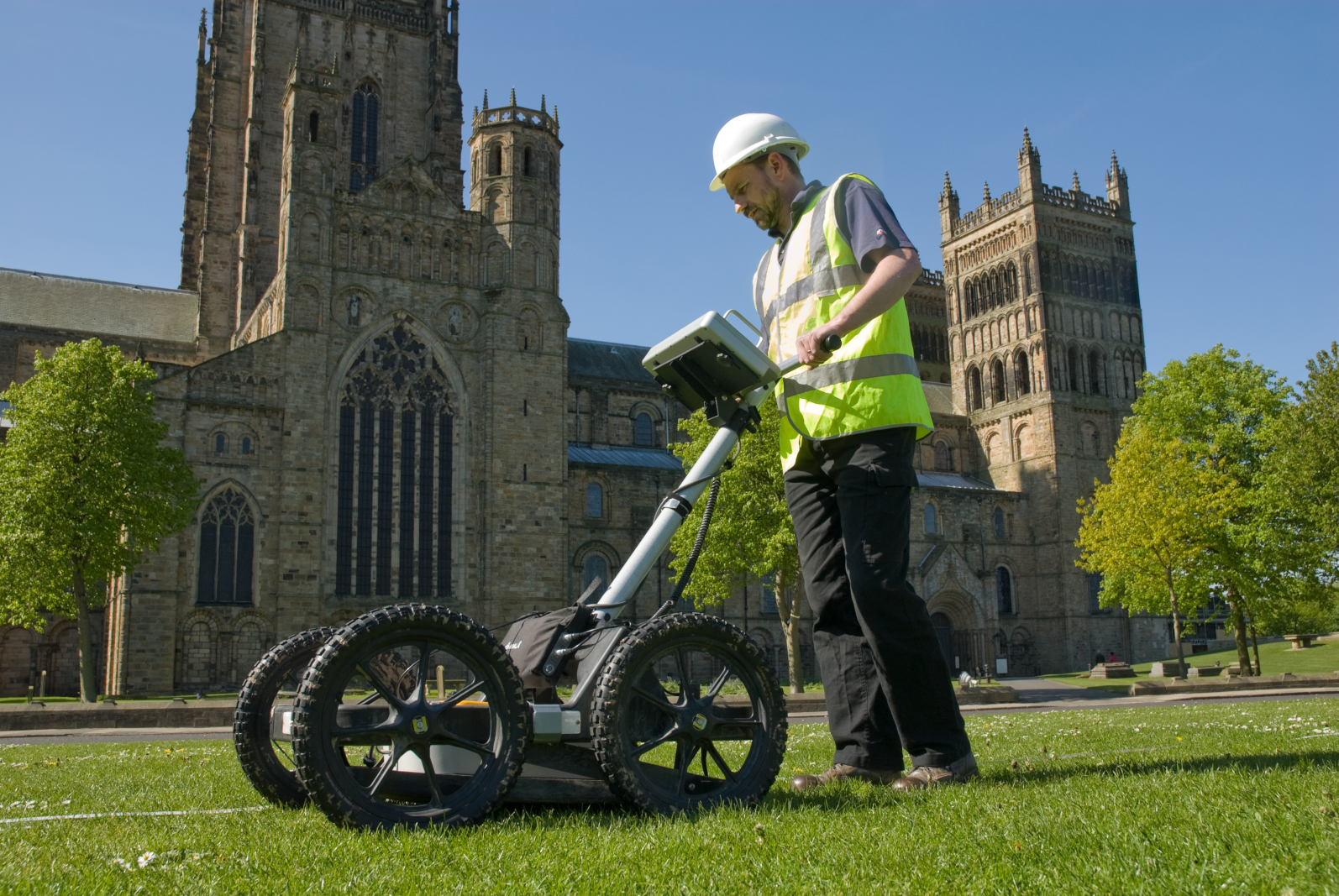 an archaeologist using GPR to survey Palace Green outside Durham Cathedral